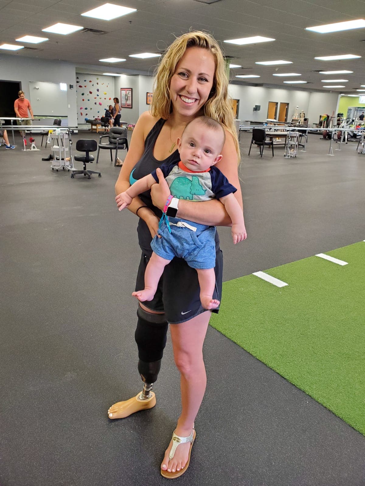 My first visit to Prosthetic & Orthotic Associates (POA) as a new mom, five months postpartum. I approached the challenge of balancing motherhood and life as an amputee with optimism and an open heart. Pictured with me is baby Gordon.